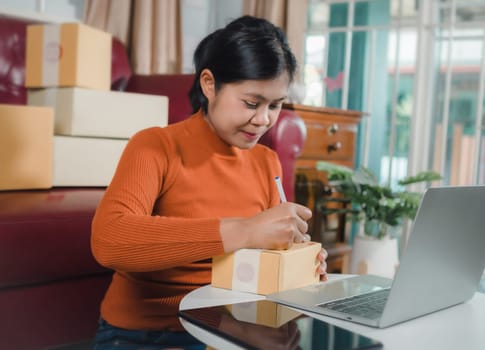 Asian woman receive order on laptop, Startup small business entrepreneur SME, Success young Asian small business owner home office, Online sell marketing delivery, Ecommerce concept, Online business.