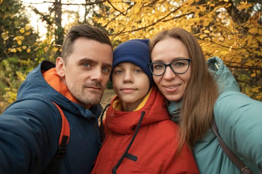 Happy family selfie in autumn park on fall nature background