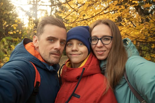 Happy family selfie in autumn park on fall nature background