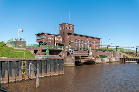 Harlesiel, Germany - April 02, 2023: Perspective view of the lock, the sluice inlet and the pumping station inlet at the inner harbor basin.