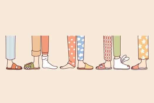 Legs of people from pajama party, in different pants and slippers, attending themed holiday for friends. Children pajama party for classmates of students in same school, to find new friends