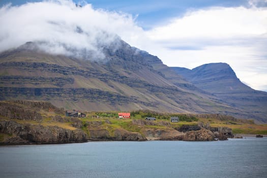 Icelandic Landscape: Houses in Foggy Mountains. Horizontal shot