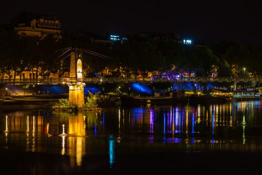 Old Passerelle du College bridge over Rhone river in Lyon, France at night
