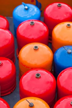 Bright metal gas bottles. Vertical outdoor shot