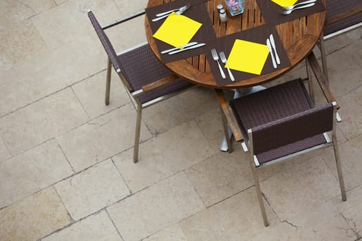Outdoor summer cafe tables with chairs. View from above. Copy space