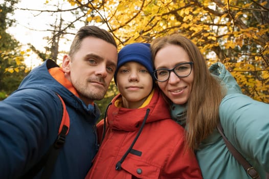 Happy family selfie in autumn park on fall nature background