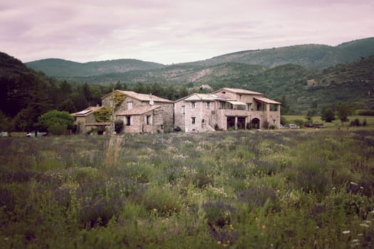 Stone farmhouse in Provence mountains, France. Horizontal filtered shot