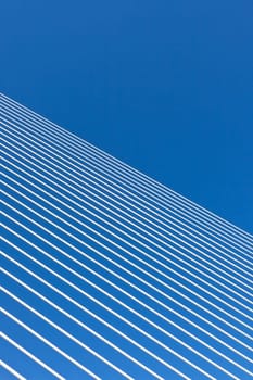 Modern bridge suspension webbings on bright blue sky background
