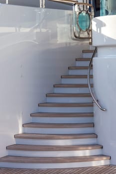 wooden stairs up on sundeck of the luxury yacht on sunny day