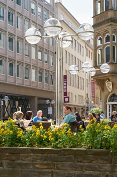 some people sit in a café in Cologne and take a break