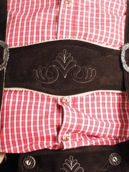 Close-up of lederhosen with traditional shirt in check pattern, Oktoberfest concept, Bavarian clothing