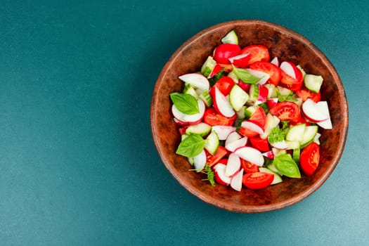 Vegetarian salad of radishes, cucumber and tomatoes. Diet menu.