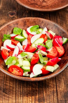 Vegetarian salad of radishes, cucumber and tomatoes. Diet menu.