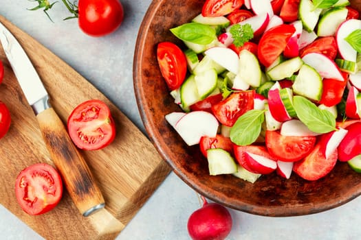 Vegetarian salad of radishes, cucumber and tomatoes. Diet menu.