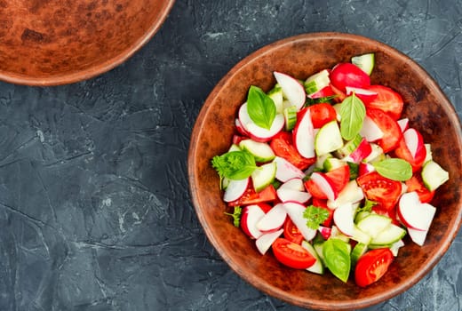 Vegetarian salad of radishes, cucumber and tomatoes. Diet menu.