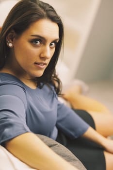 Living room, A businesswoman is enjoying her free time while relaxing at home after a long day at work
