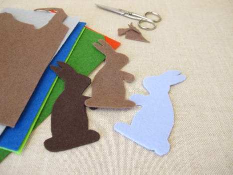 Easter bunnies cut out of colorful felt with scissors