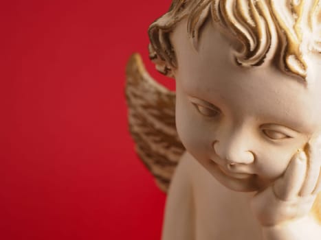 Close-up of a Christmas angel against a red background, Christmas or holiday background