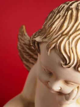 Close-up of a Christmas angel against a red background, Christmas or holiday background