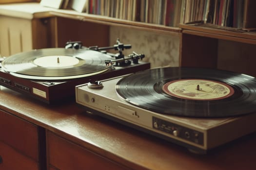 Two vintage turntables with vinyl records on wooden surface, album collection in background, music enthusiast concept.
