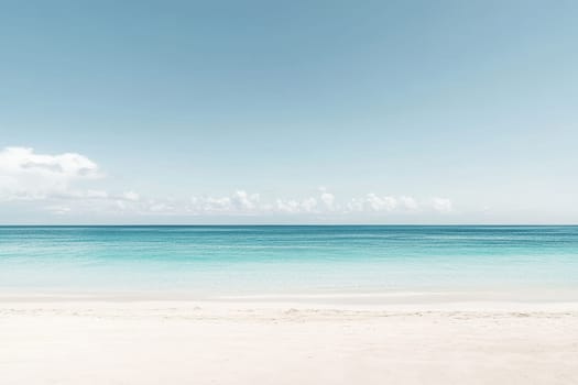 Serene tropical beach with turquoise water, white sand, and a pale blue sky dotted with wispy clouds on the horizon.