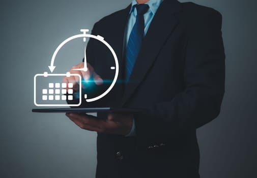 Businessman marking dates on virtual calendar, Time management concept, Planning work to increase efficiency, Business project planning, Effective time management and reduce working time.