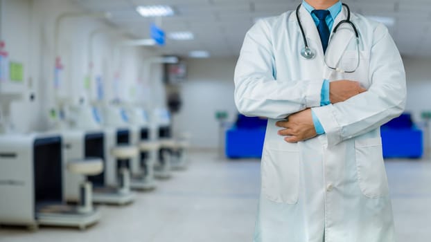 Doctor in a lab coat is standing on the background inside a hospital, Medical concept, Medical information search, Concept of treating disease. Insurance concept, Concept for commercial business.