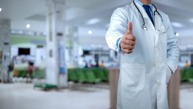 Doctors standing with thumbs up or Ok sign in hospital office, close-up. Physicians ready to examine and help patients, Medical help, Best treatment, Insurance in health care and medicine concept.