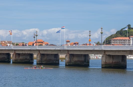 Ribadesella, Spain - July 13th, 2024: Ribadesella river bridge, that divides the fishing port in two, Asturias, Spain