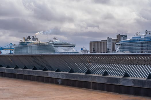 A partial view of the cruise port of Barcelona, in Spain. The Catalan city is an important destination for large tourist cruises operating in the Mediterranean Sea. Photograph taken from the new eastern promenade called Trencaones.
