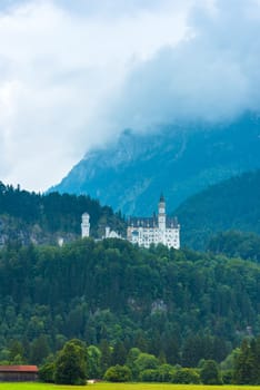 GERMANY, HOHENSCHWANGAU - AUGUST 20: Bavarian Neuschwanstein Castle view in a summer foggy weather on August 20, 2015