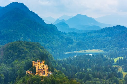GERMANY, HOHENSCHWANGAU - AUGUST 20: Bavarian Hohenschwangau Castle view in a summer foggy weather on August 20, 2015