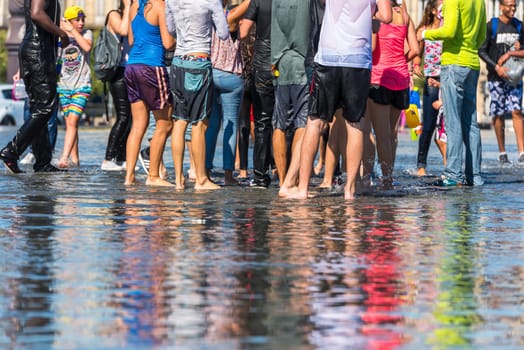 FRANCE, BORDEAUX - SEPTEMBER 20: People having fun in a mirror fountain in front of Place de la Bourse in Bordeaux, France on September 20, 2015