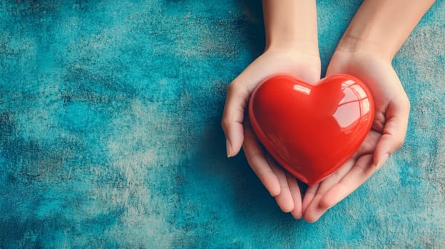 A human hands holding a glossy red heart , representing support for heart disease awareness and the importance of health care.Top view,  copy space. AI generated