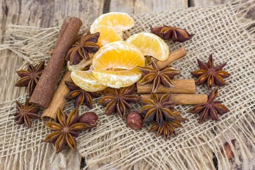 cinnamon sticks, star anise spices, tangerine and nuts - christmas time