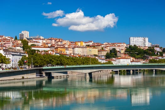 Cityscape of Lyon, France with reflections in the water. Bright sunny day