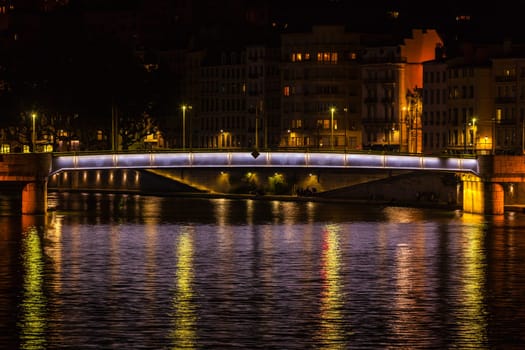 Cityscape of Lyon, France with reflections in the water at night