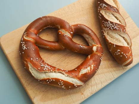 Tasty Bavarian pretzel on a wooden board, Traditional German food, Oktoberfest concept