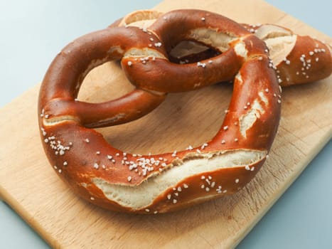 Tasty Bavarian pretzel on a wooden board, Traditional German food, Oktoberfest concept
