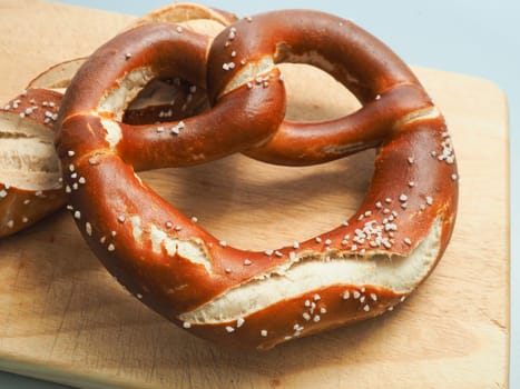 Tasty Bavarian pretzel on a wooden board, Traditional German food, Oktoberfest concept