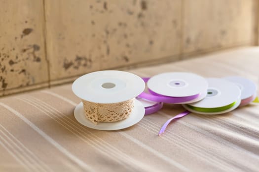 Rolls with pastel color ribbons and lace. Shot with shallow depth of field. Natural light