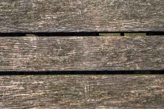 Close up of old abandoned rickety foot bridge. Old wood texture background coming from natural tree. The wooden panel has a beautiful dark pattern.
