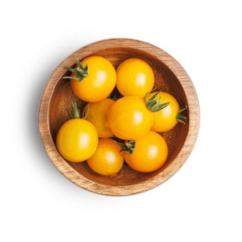 Small yellow cherry tomatoes in bowl isolated on a white background.
