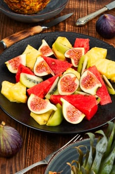 Fruit salad with pineapple, watermelon, kiwi and figs. Healthy food
