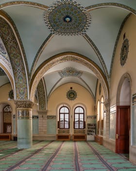 Interior of Icherisheher Juma Mosque in the Old City of Baku, Azerbaijan, with Intricate details featuring stunning arches and colorful artistic motifs