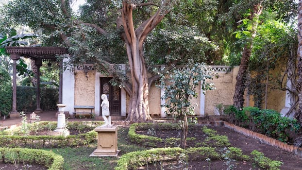 Lush greenery frames the tranquil garden of Prince Naguib Palace in Cairo, Egypt, showcasing classical Mamluk architectural elements