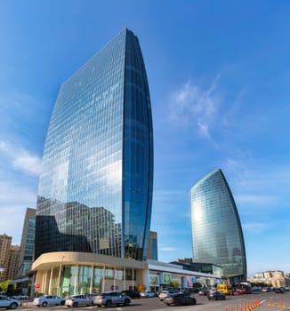 Baku, Azerbaijan - May 10 2024: Tall glass Port Baku Towers reflect sunlight, showcasing modern architecture in a bustling urban environment