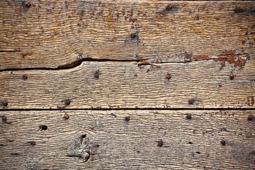Wooden surface with old metal rivets background. Horizontal shot