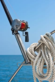 Fishing rod and reel on a sailing yacht. Vertical shot