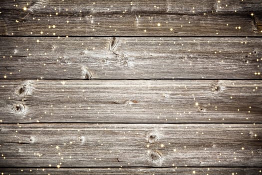 Old wooden planks surface background with golden sparkles